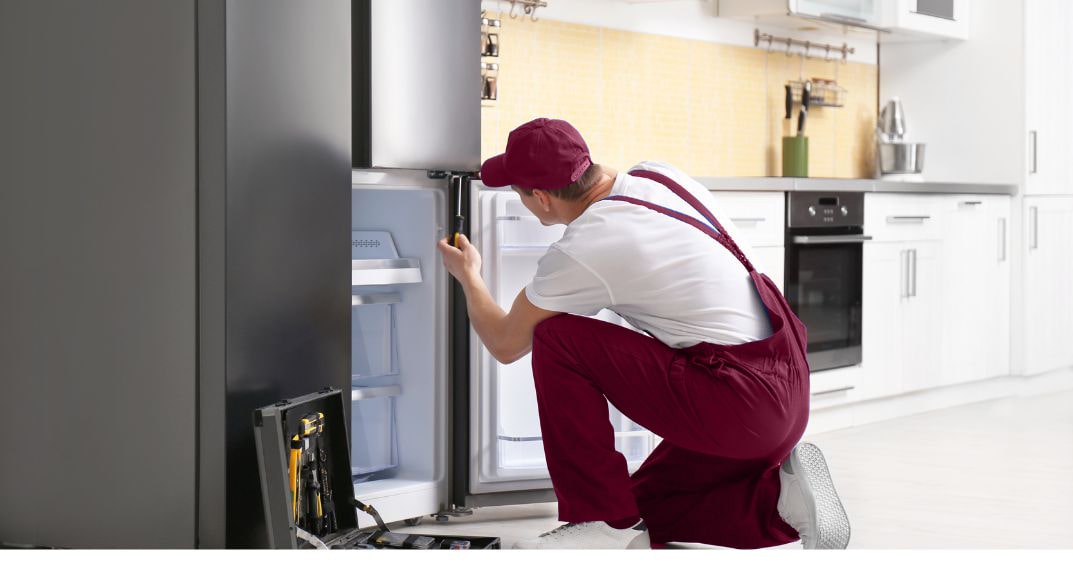 Appliance Fix BCS in College Station, TX - man repairing freezer